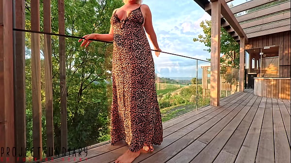 Busty brunette in red sequin mini-dress gets wild and naked on balcony, fucking hard as curious neighbors watch